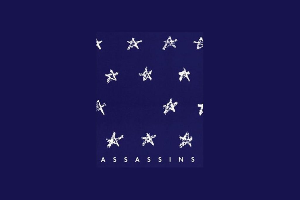 Assassins musical poster with white stars arranged in rows on dark blue background with ASSASSINS text below