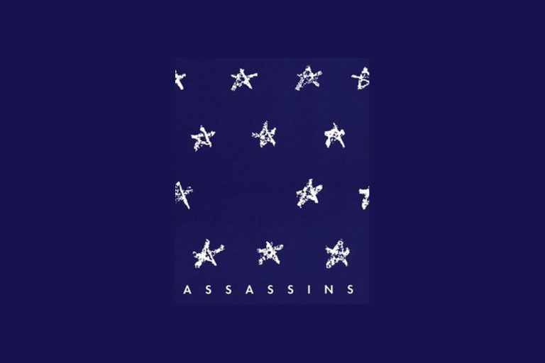 Assassins musical poster with white stars arranged in rows on dark blue background with ASSASSINS text below