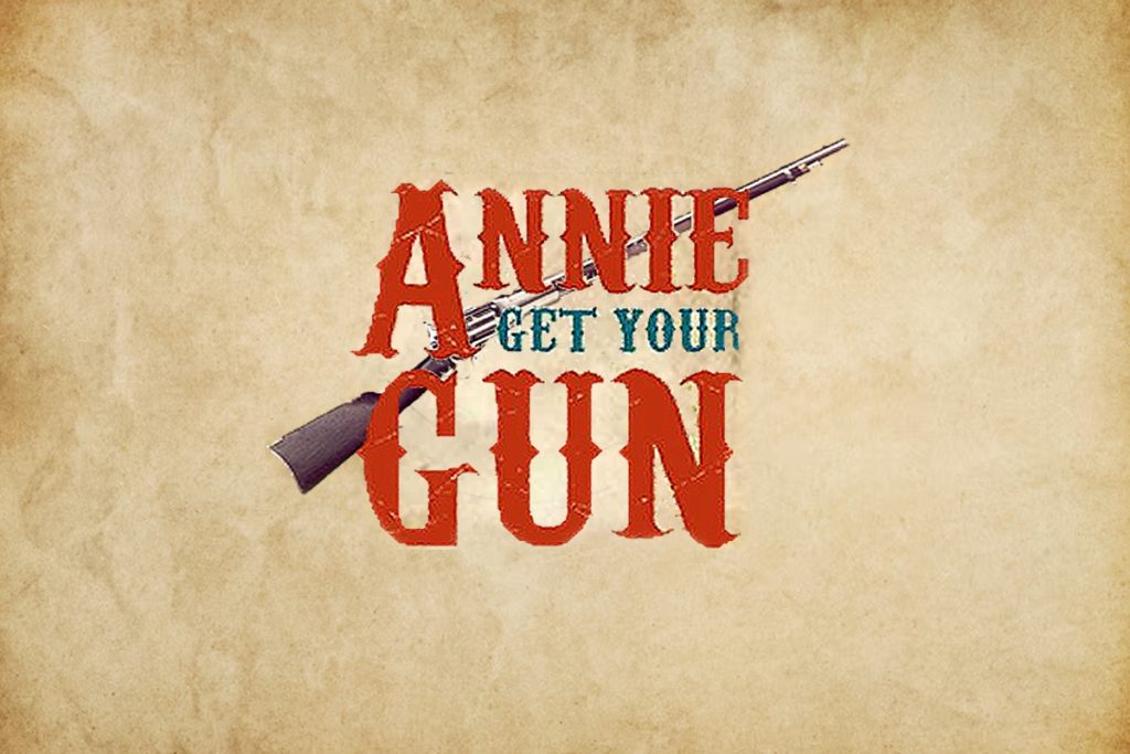 Annie Get Your Gun musical logo with vintage rifle and aged parchment background
