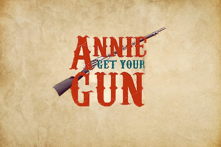 Annie Get Your Gun musical logo with vintage rifle and aged parchment background