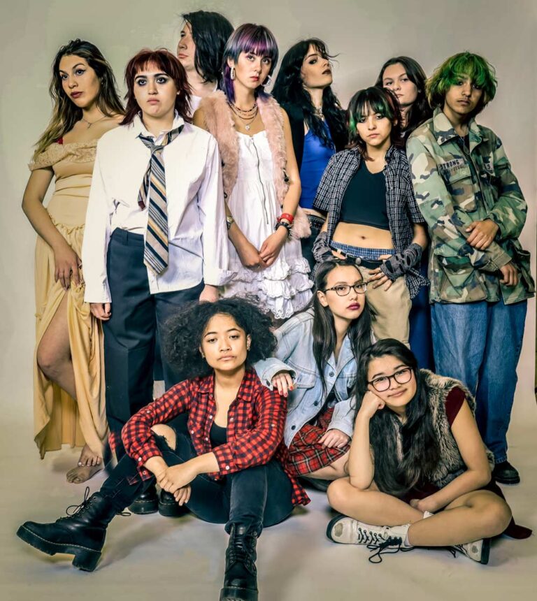 Group of diverse young women in various alternative fashion styles posing together for portrait photo shoot