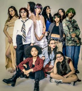 Group of diverse young people in trendy casual outfits posing together for a fashion portrait against neutral background